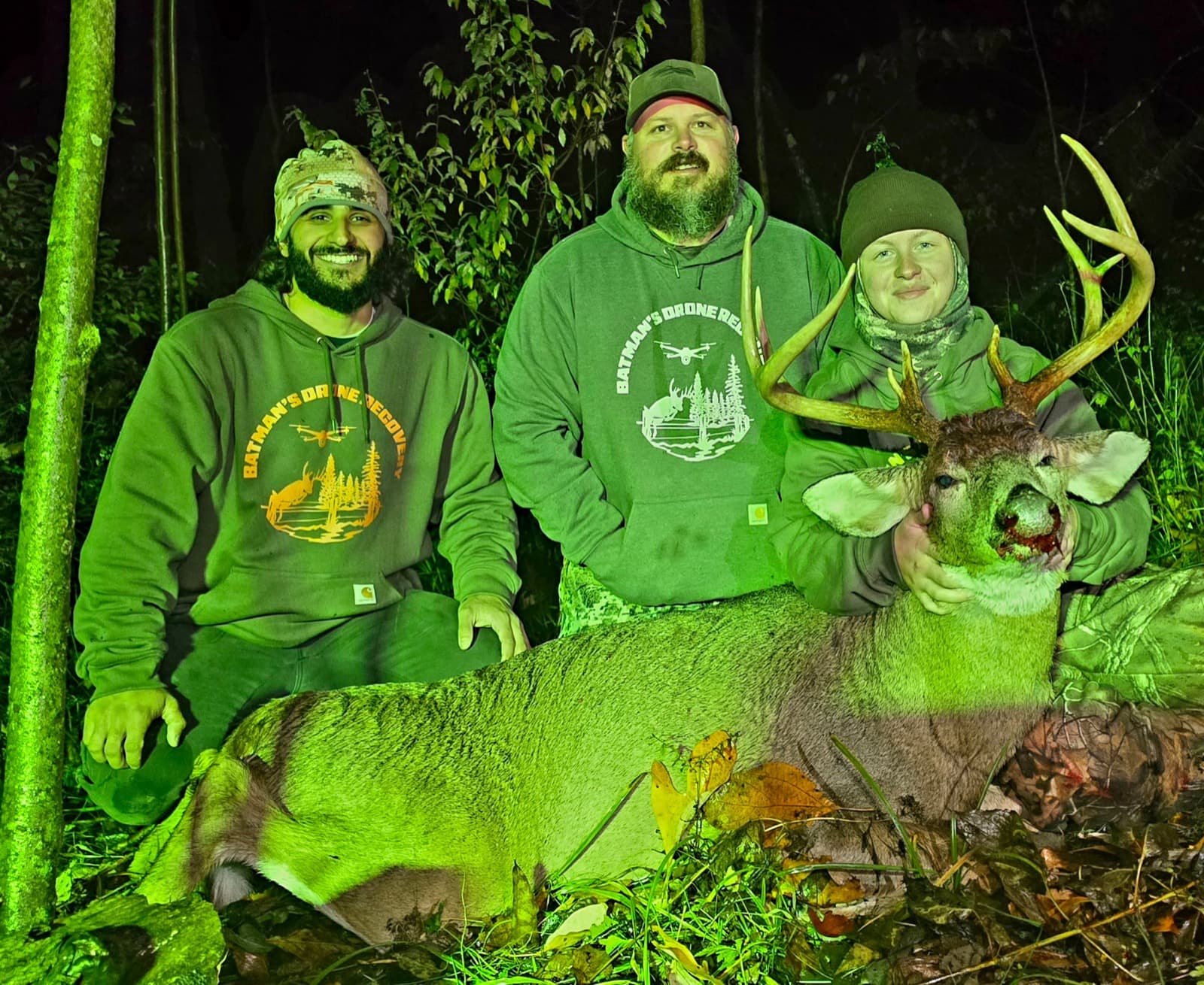 The crew with a recovered buck under the recovery light