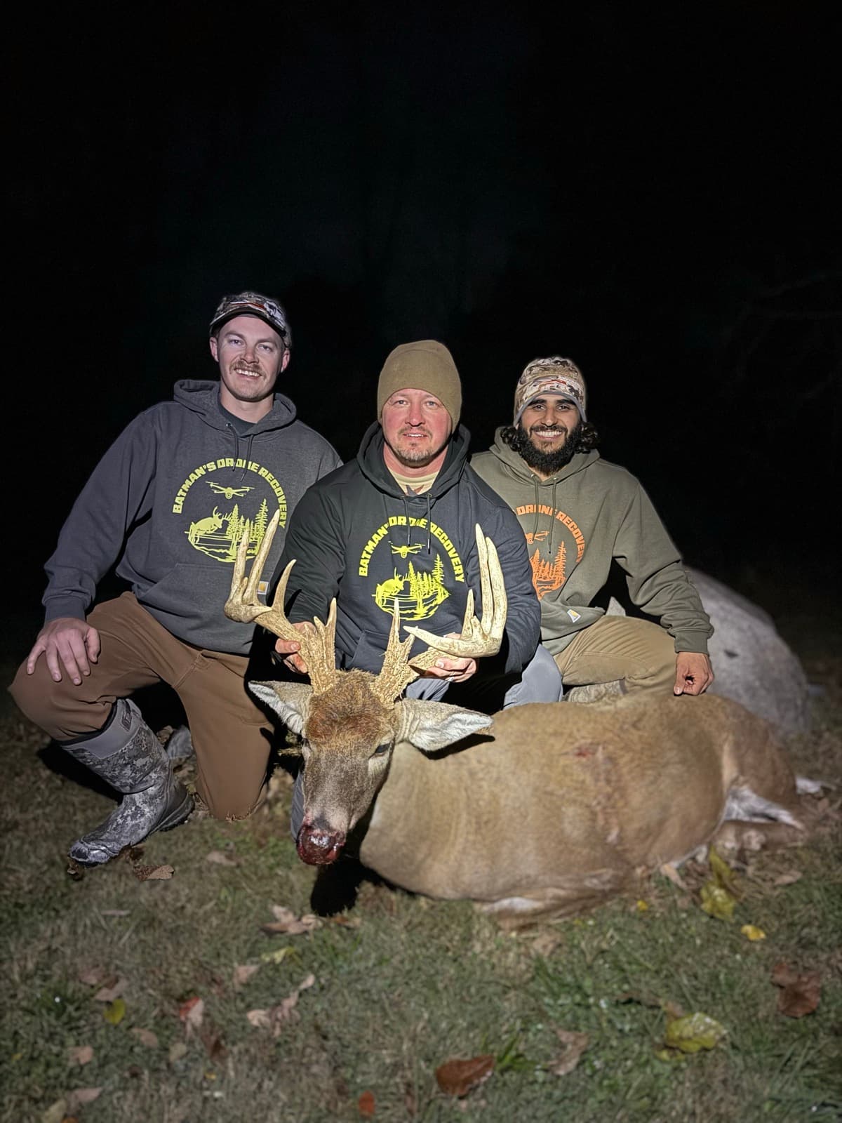 The crew with a buck recovered after dark