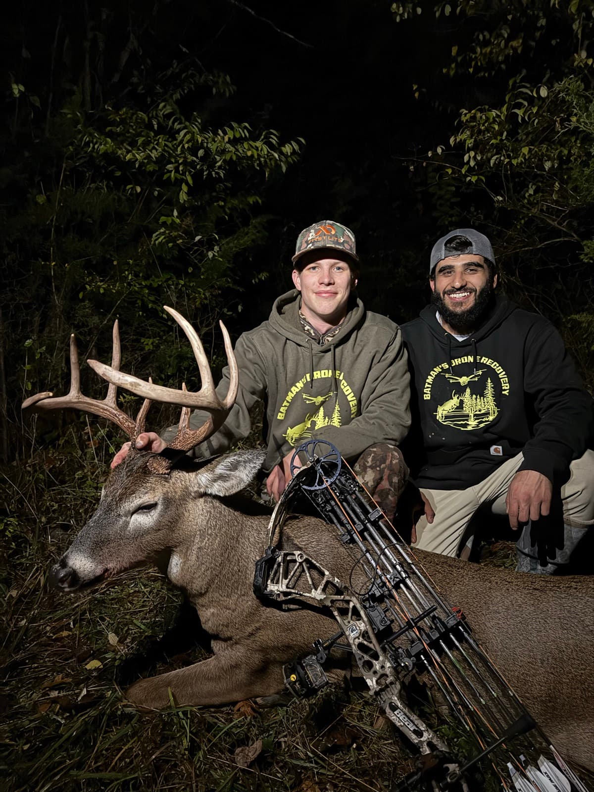 Two hunters with a buck recovered on a night bow hunt